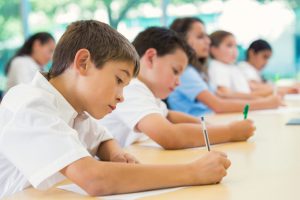 Diverse students taking test in private elementary school