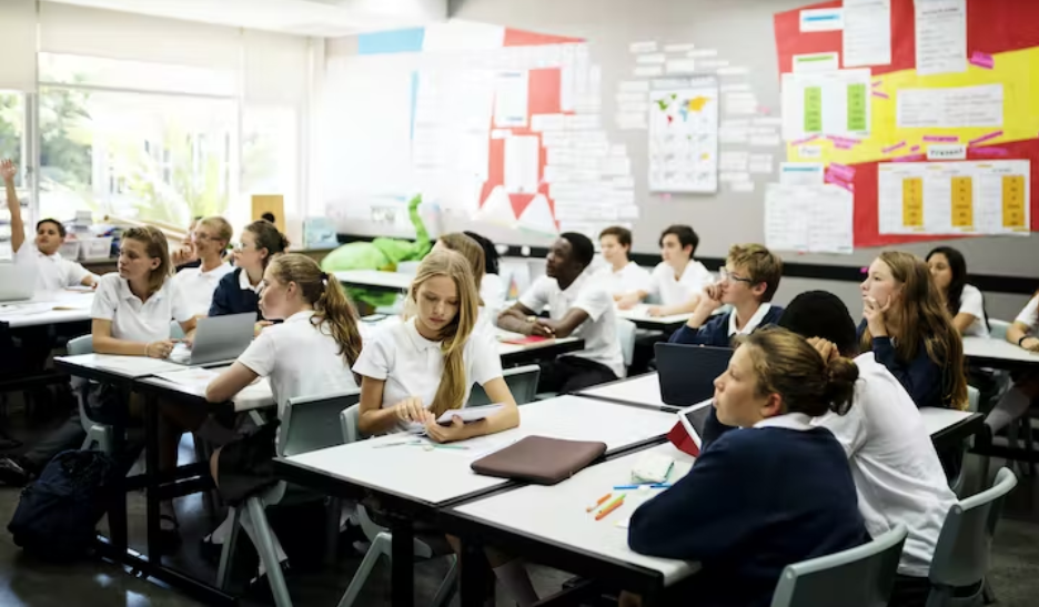 students in school room look up from their desks in a classroom