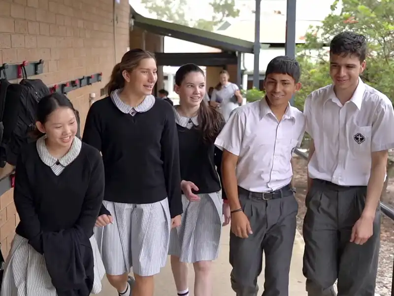 a group of high school age students walking and talking